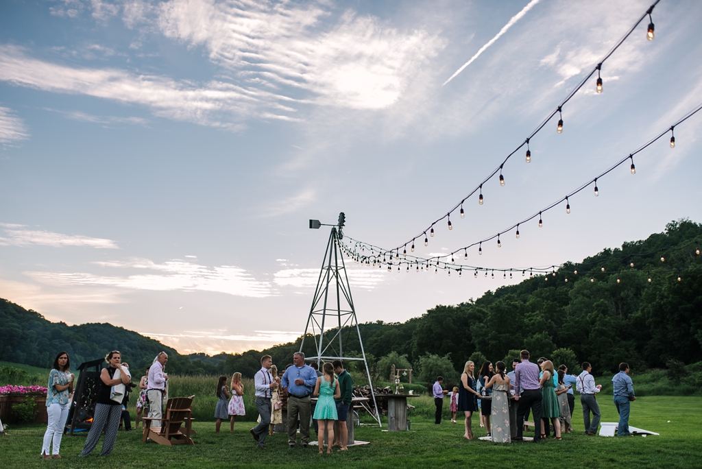 lights strung up on windmill over outdoor wedding reception
