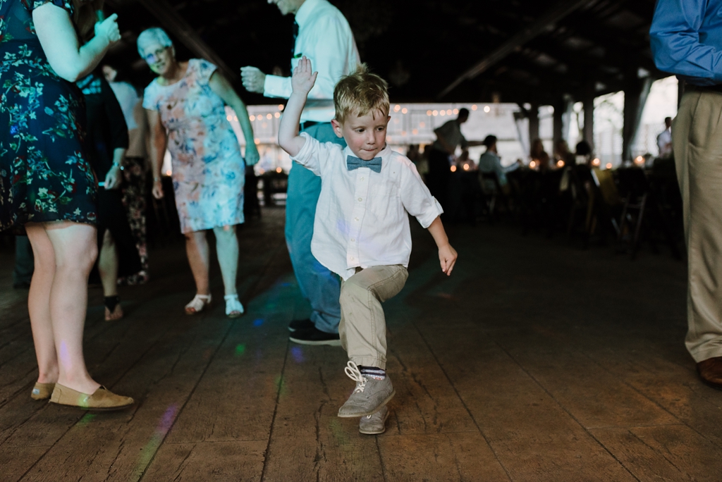 young boy dances at barn wedding reception