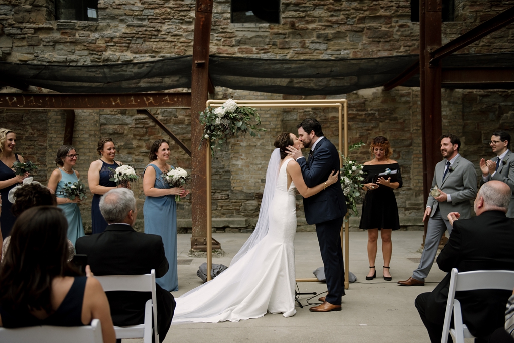 bride and groom kiss at mill city museum wedding