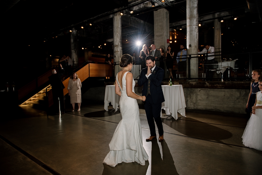 emotional groom dances with bride at reception