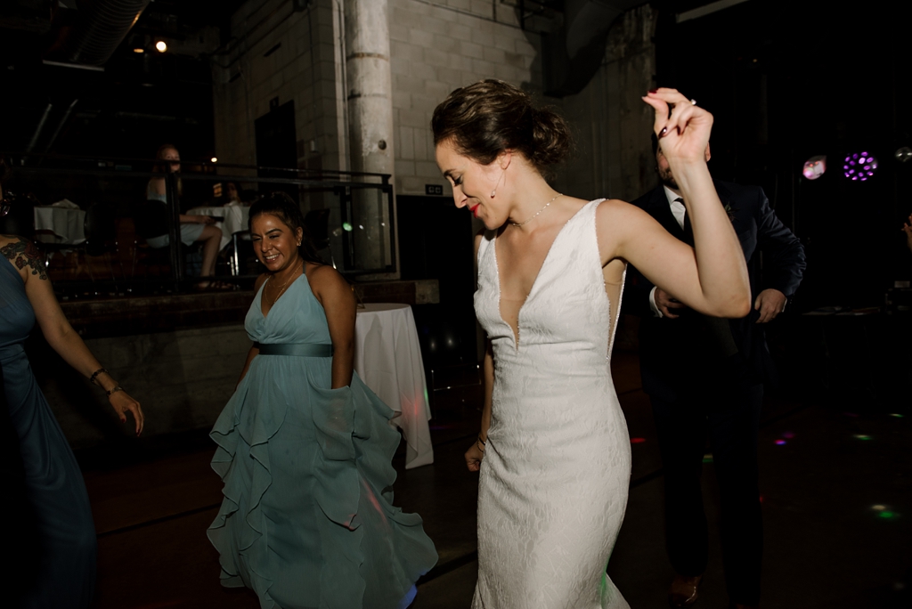 bride dancing with guests at wedding reception