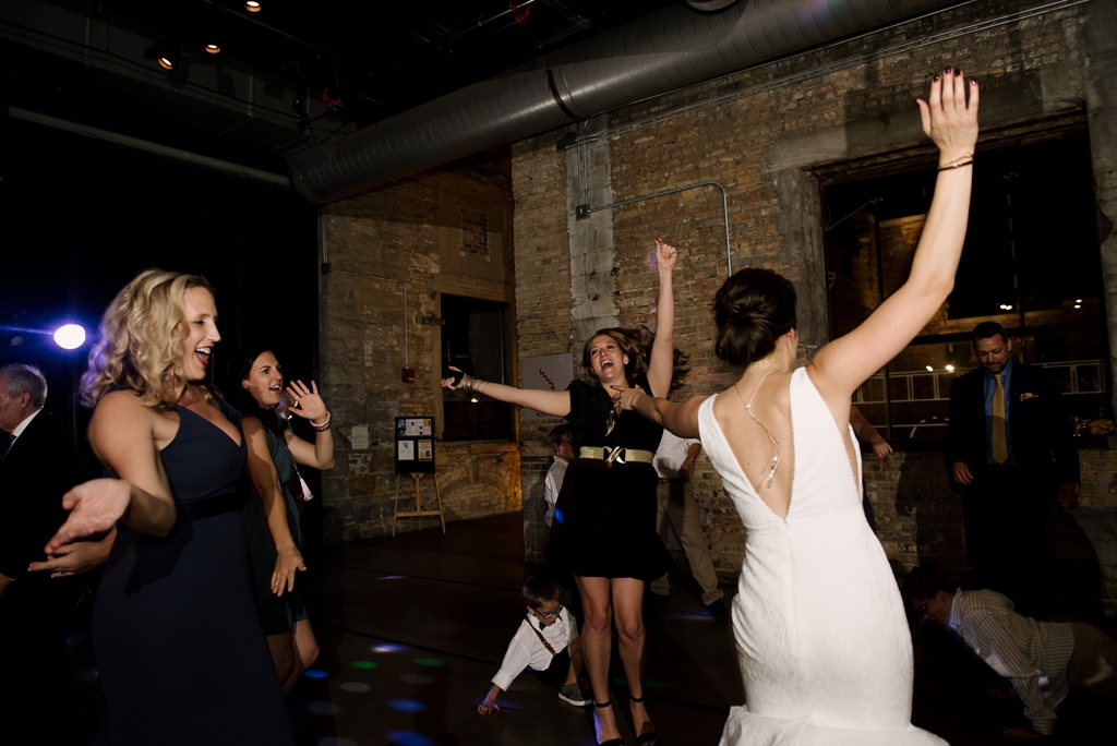 bride and guests dancing at reception