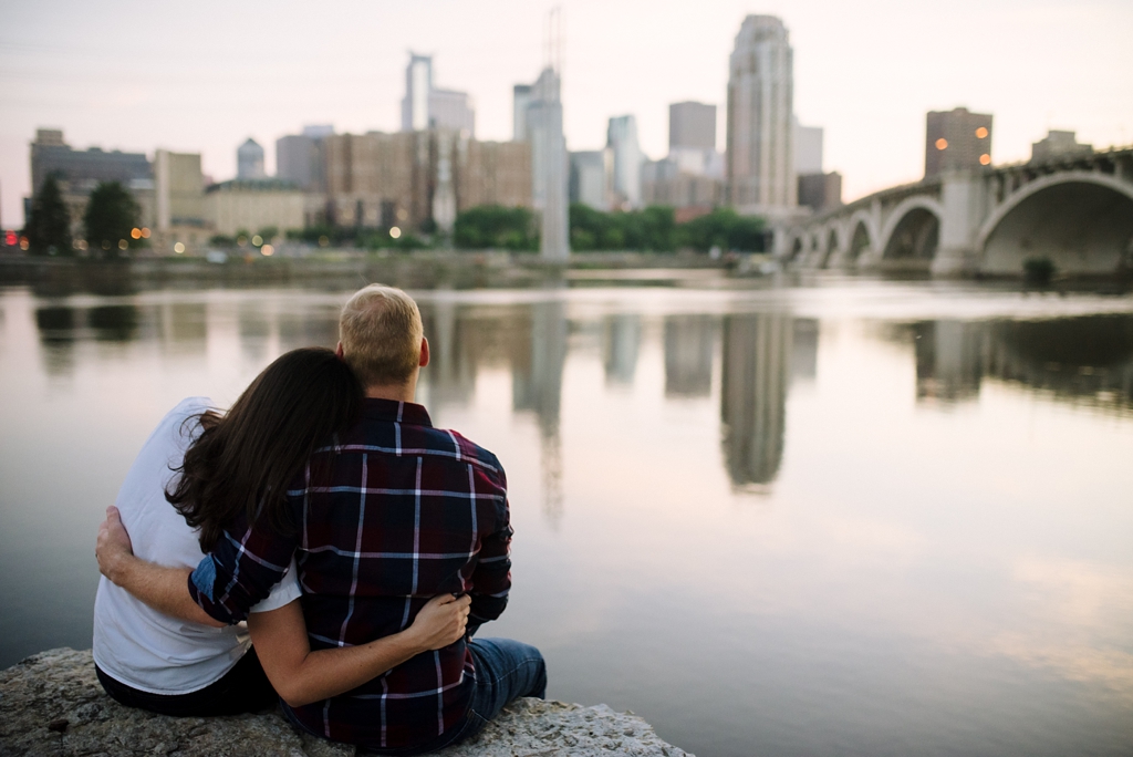 couple watching sunset over mississippi river and minneapolis