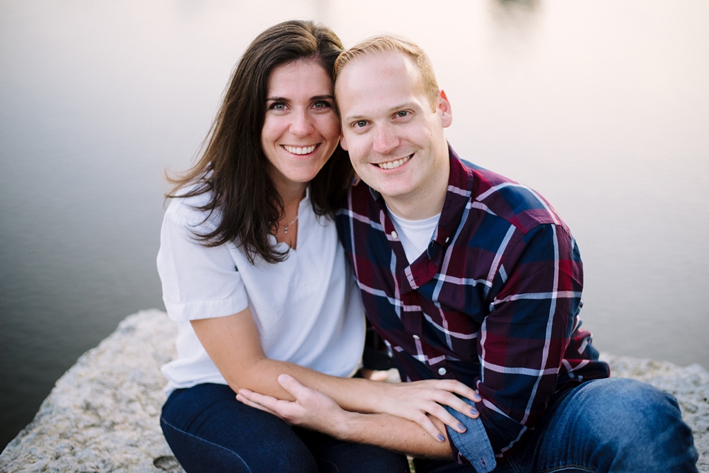 couple sitting beside mississippi river during photo session