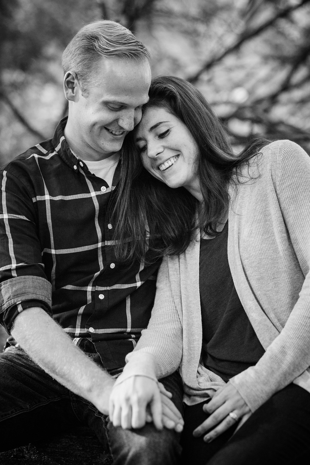 couple cuddling in black and white during anniversary session