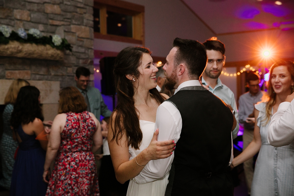 bride and groom embracing on dance floor at reception