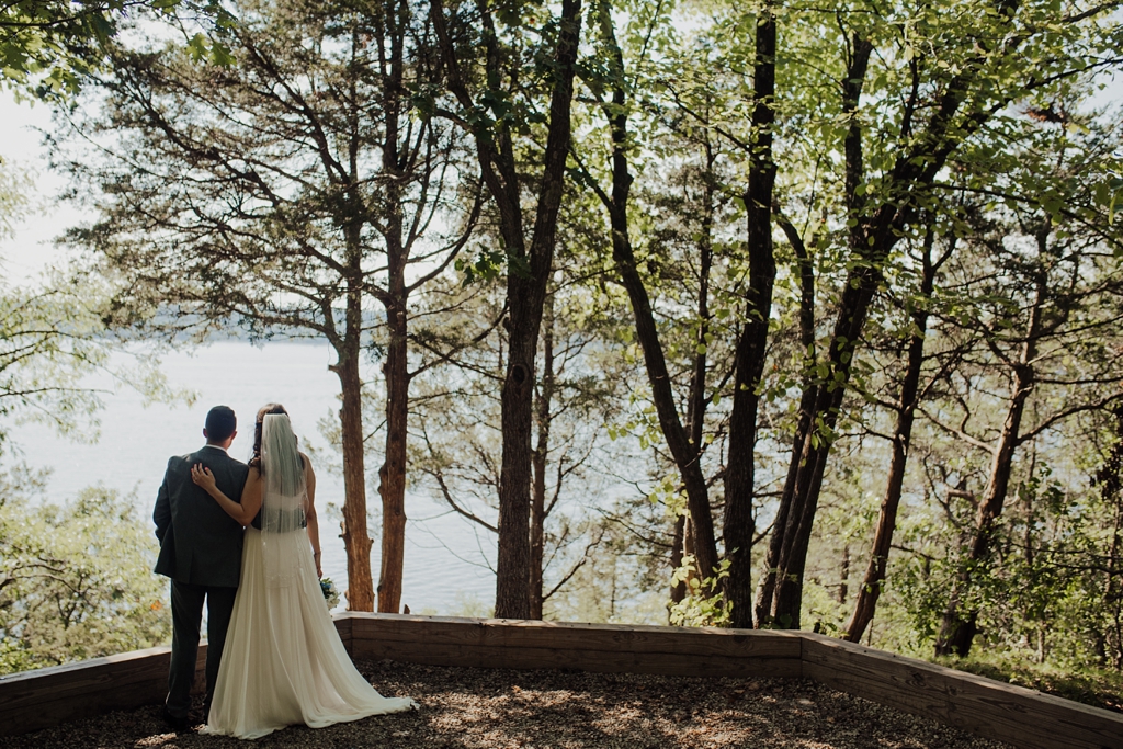 bride and groom overlooking lake
