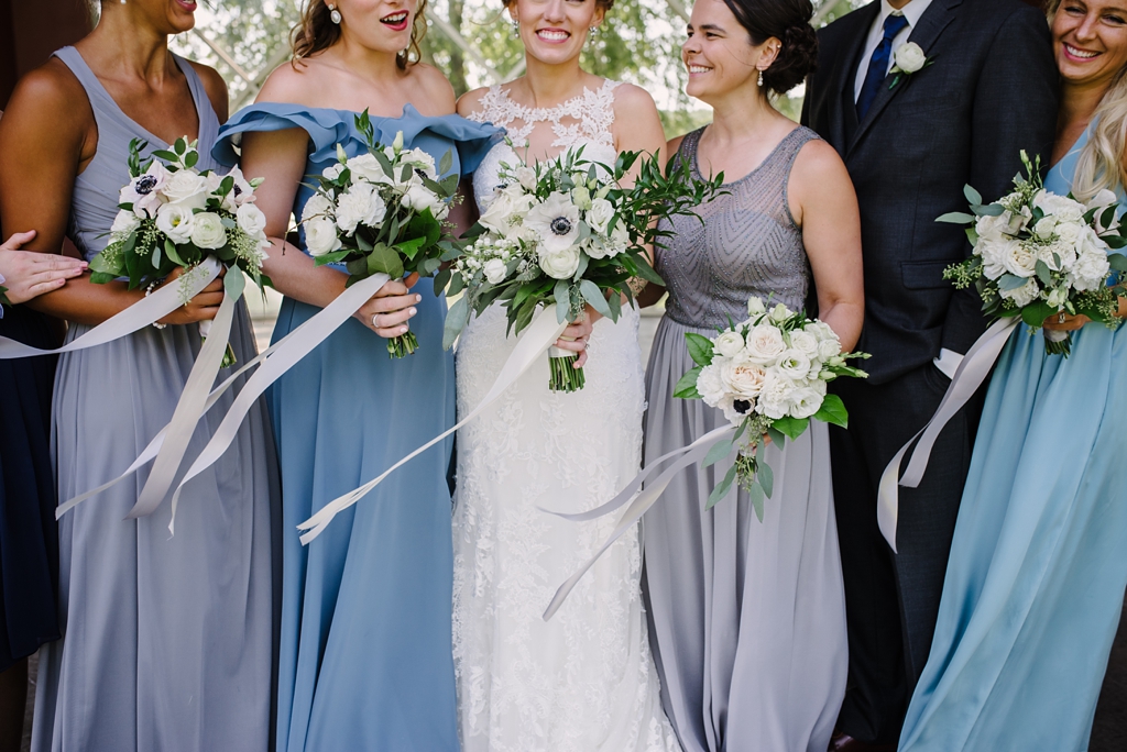 detail image of wind blowing bridal party's bouquets