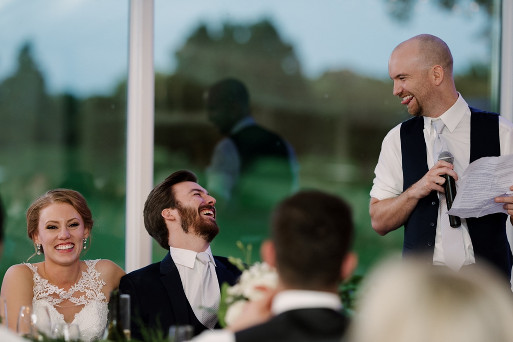 bride and groom laugh at speeches