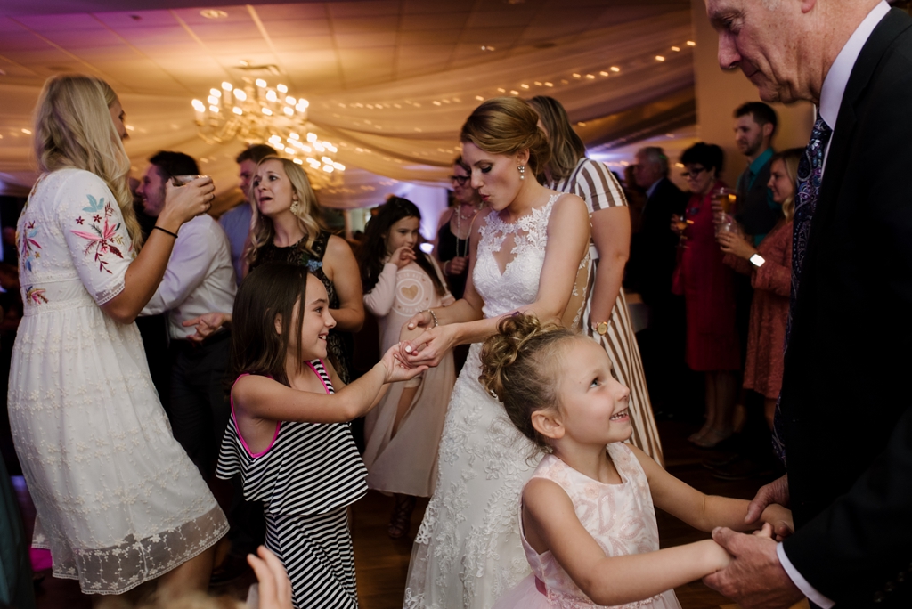 bride dances with guests at reception