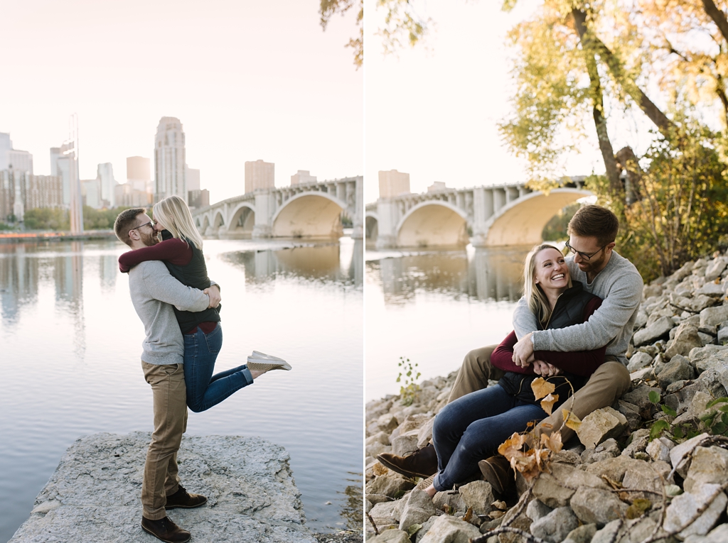 engaged couple hugging and laughing beside mississippi river