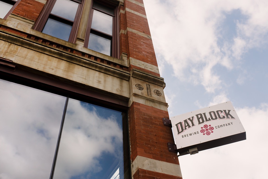 day block brewing company sign with blue sky and clouds