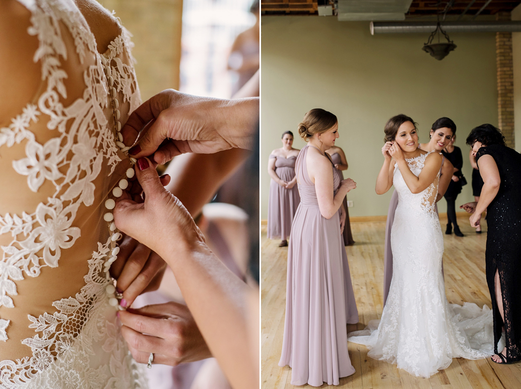 hands buttoning bride's dress; bride putting on earrings while bridesmaids watch