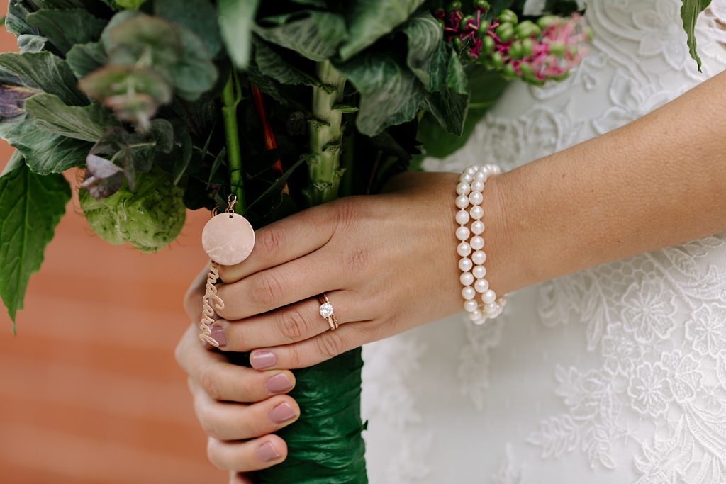 detail of bride's hands holding bouquet