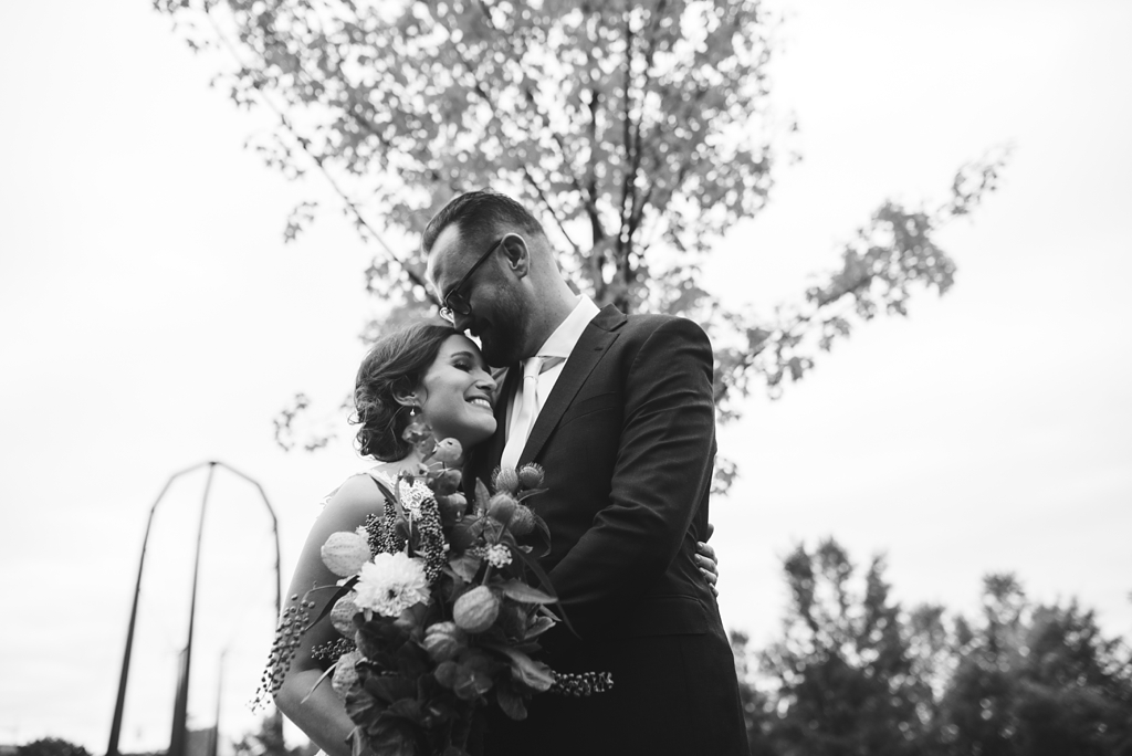black and white image of bride and groom embracing post ceremony