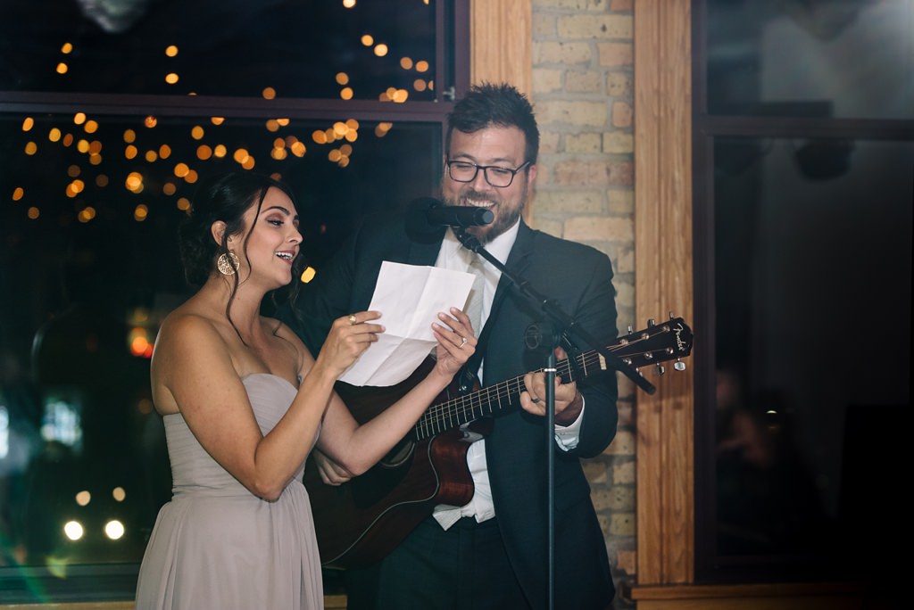 bridesmaid and groomsmen sing during wedding reception