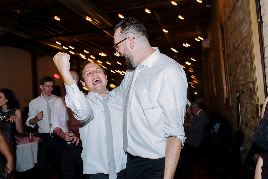 groom and groomsman dance at reception