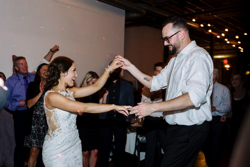 bride and groom dance at day block wedding reception