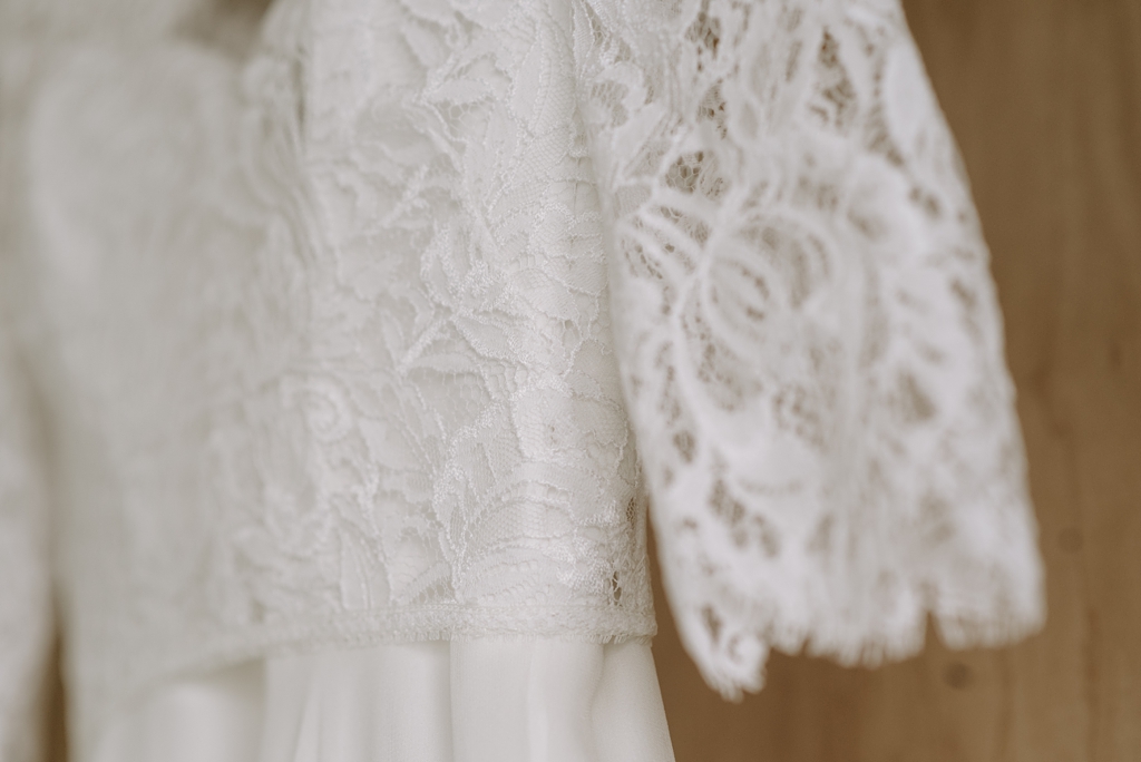 close up of lace wedding dress details