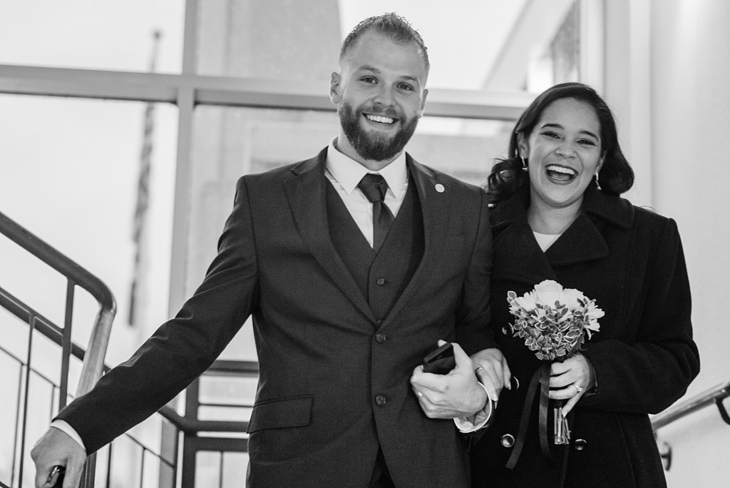 bride and groom smile after city hall wedding