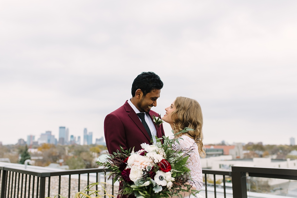 bride and groom in front of minneapolis skyline