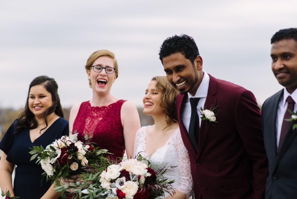 wedding party laughing during formal photos