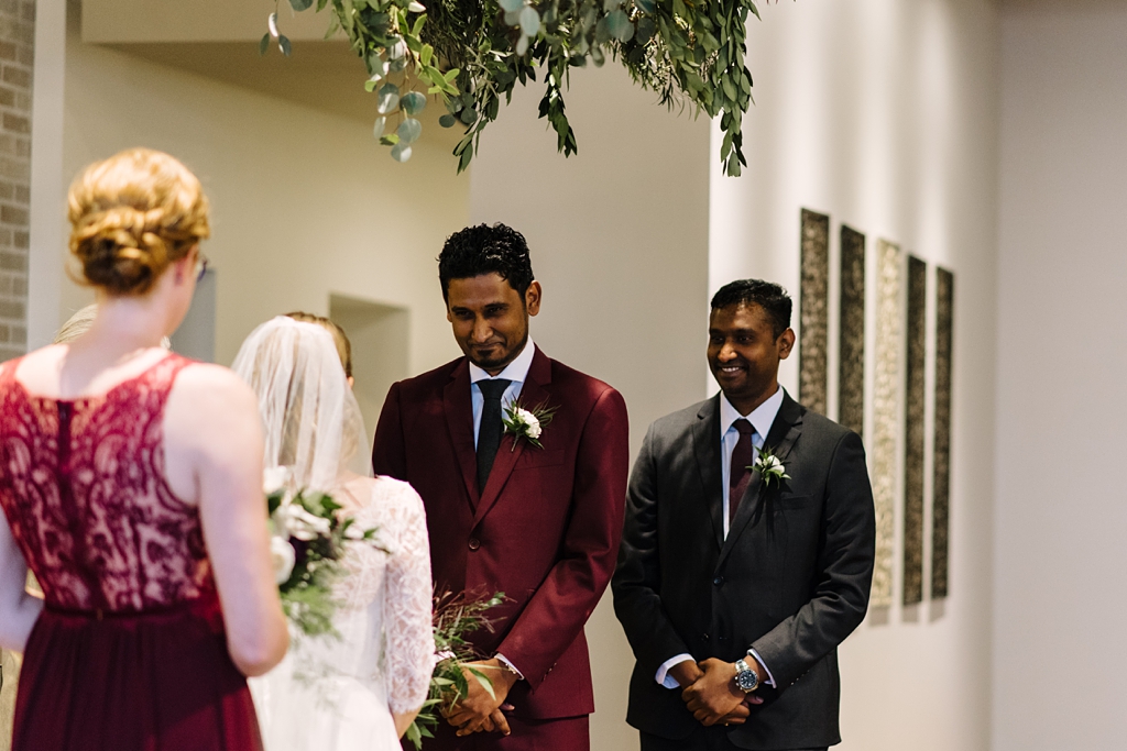 groom smiles at bride during five event center wedding