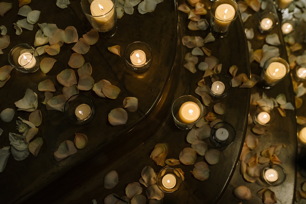 lit candles and flower petals