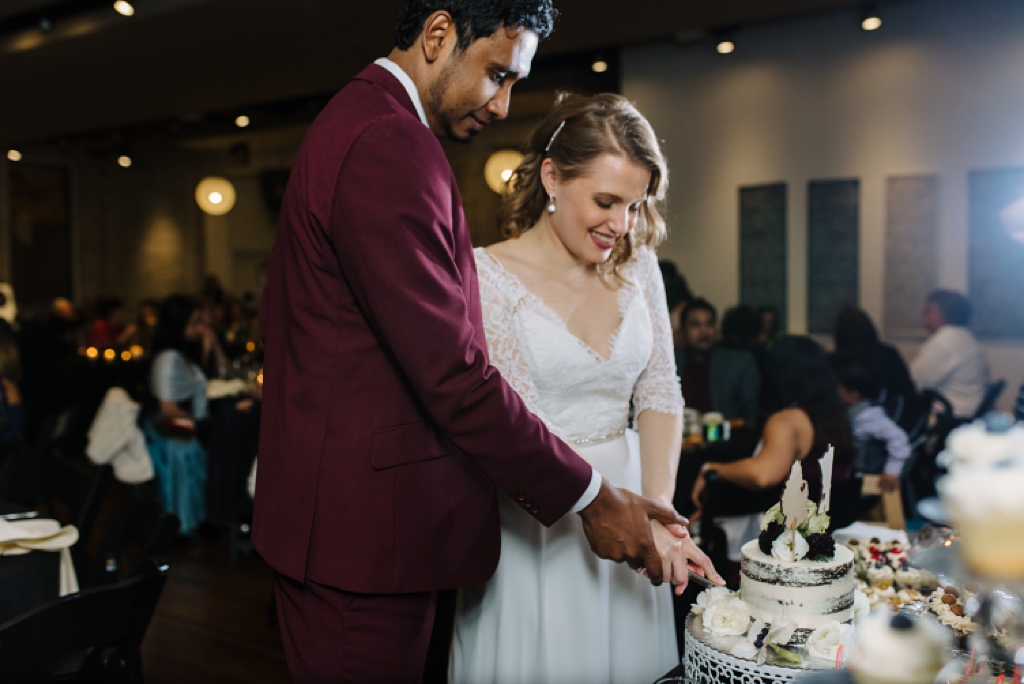 bride and groom cut cake at five event center reception