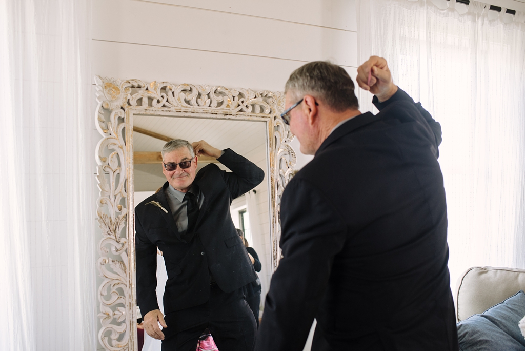 father of the bride hamming it up in front of mirror