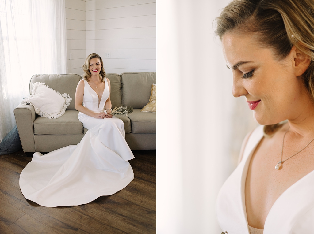 bride sitting on sofa with train of dress spread out; portrait of bride looking down and away
