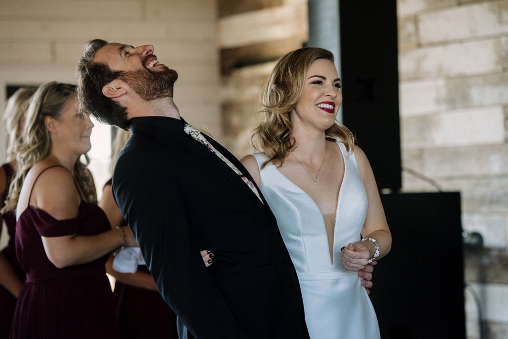 groom laughs during wedding ceremony in minnesota