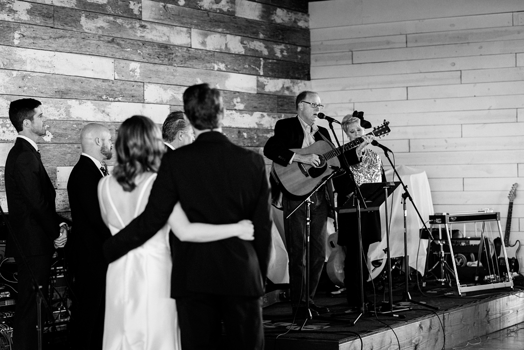 friends surprise bride and groom during ceremony with song