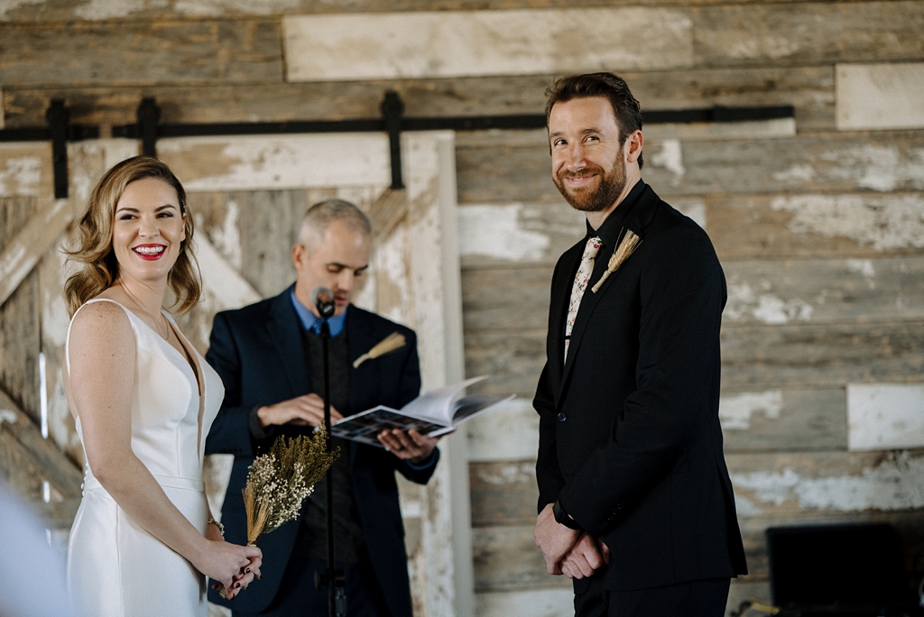 minnesota bride and groom smile at guests