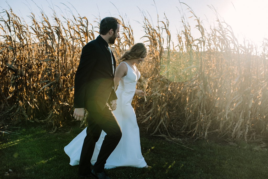 minnesota newlyweds walk beside corn field