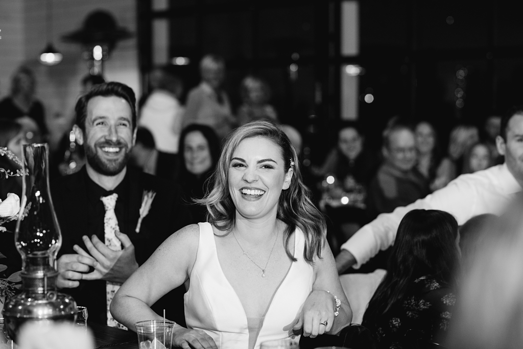 bride and groom react to reception toasts