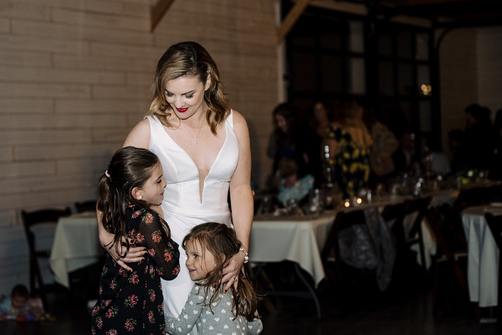 bride dances with little girls at reception