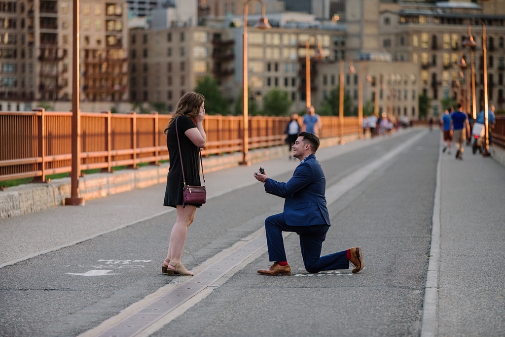 man proposes on stone arch bridge minneapolis