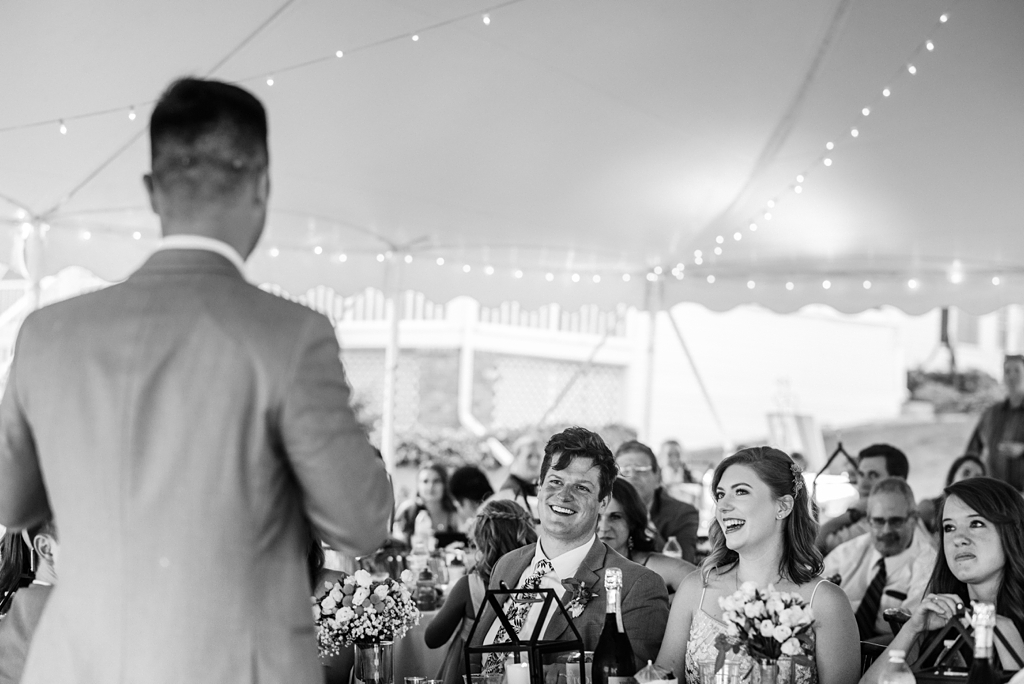 bride and groom during toasts at backyard wedding reception wayzata mn