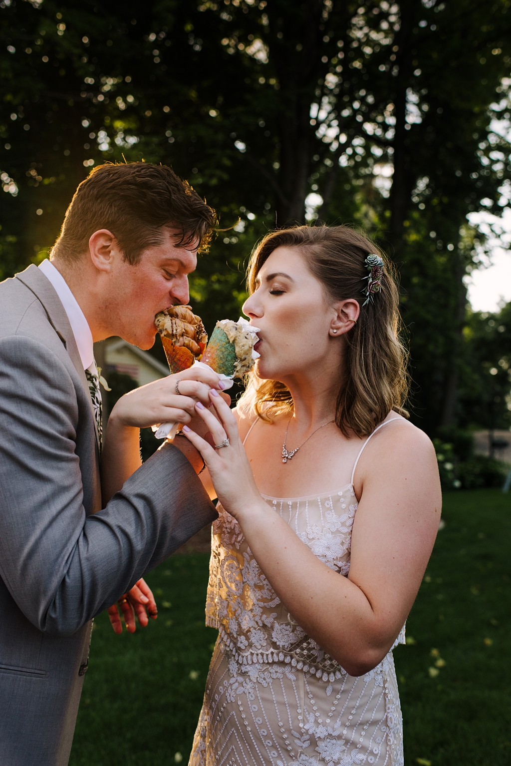 newlyweds share ice cream at wedding reception at sunset