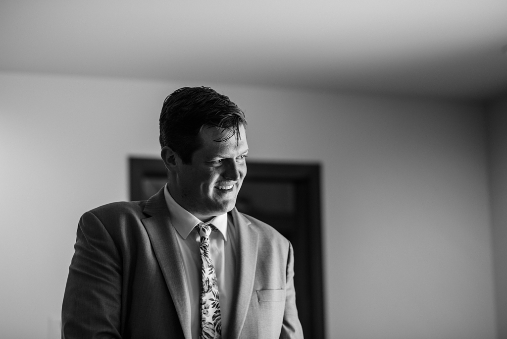 groom getting ready in black and white