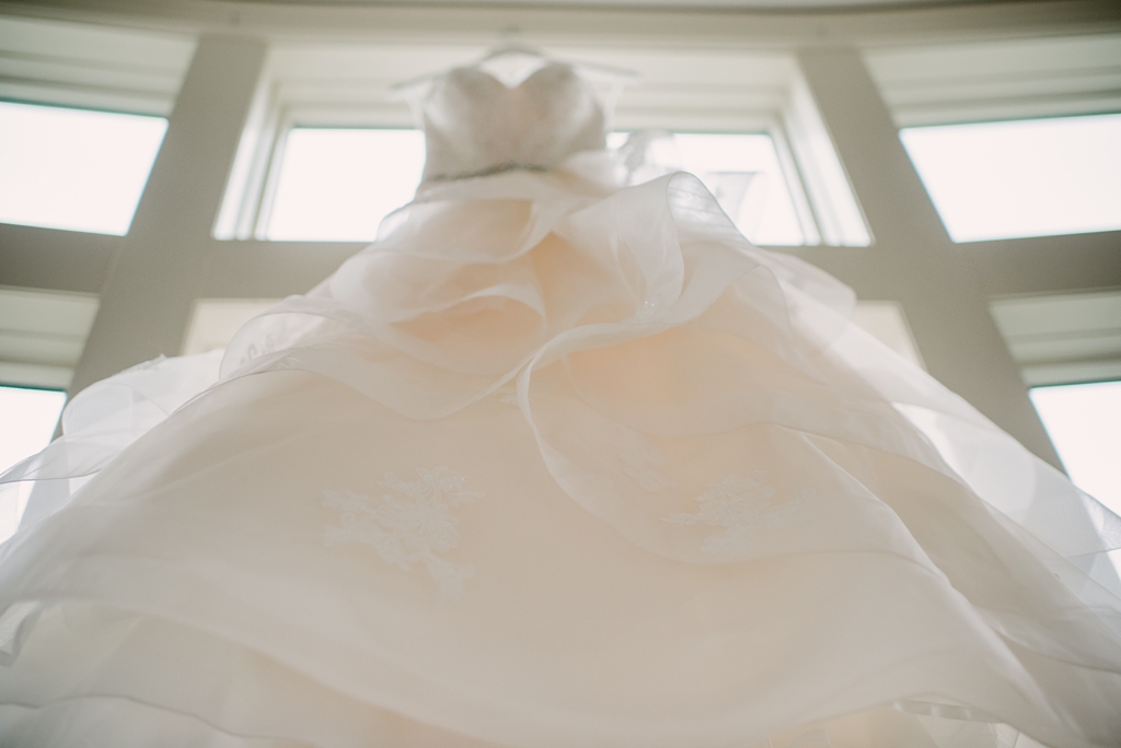 bridal gown hanging in window