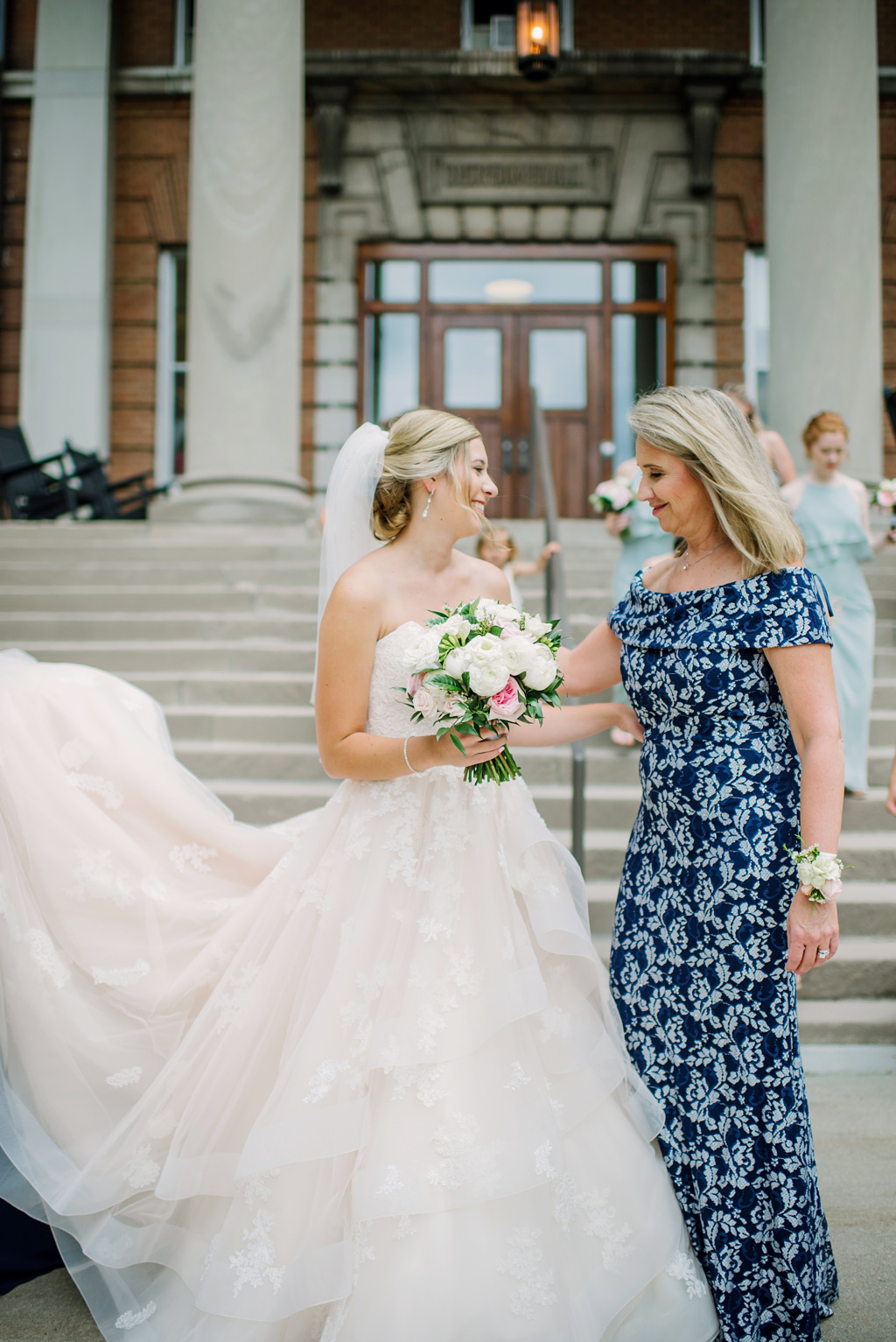 bride and mother in front of church stairs