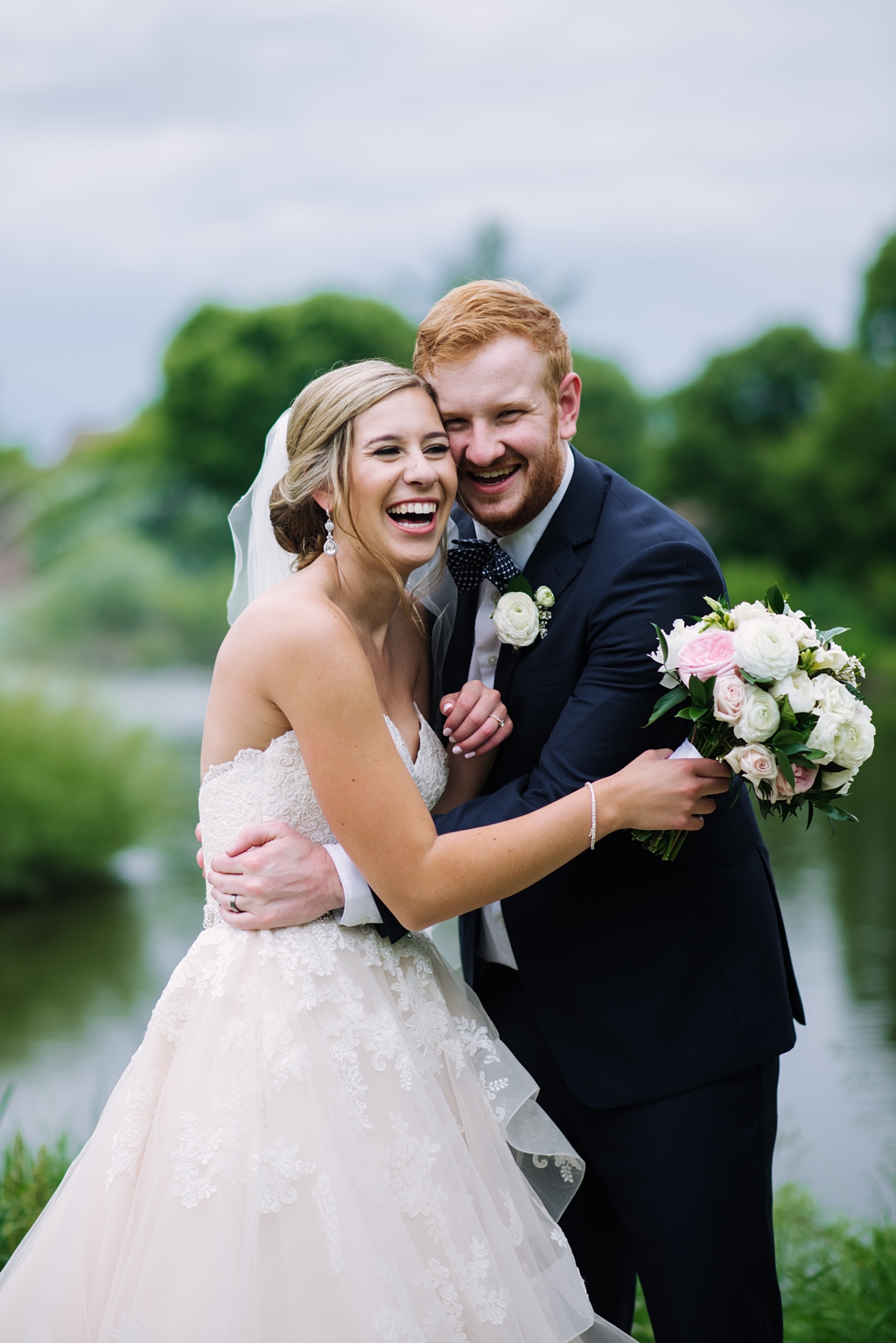 newlyweds laughing together during portraits