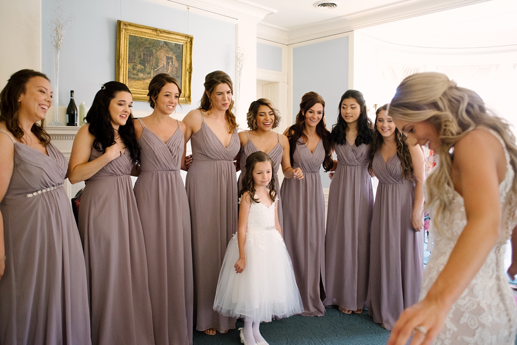 bridesmaids seeing bride in her dress for the first time