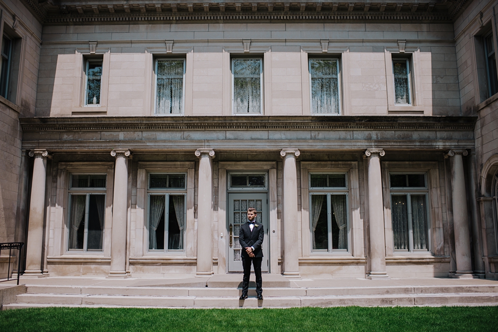 groom standing outside gale mansion