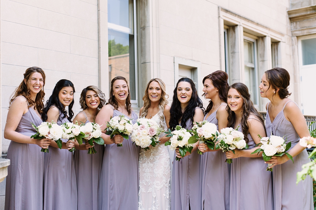 wedding party in lavender dresses with bouquets