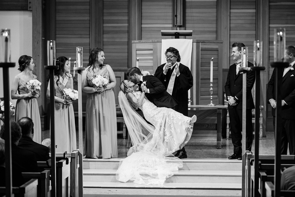 groom dips bride for first kiss at gale mansion event center wedding