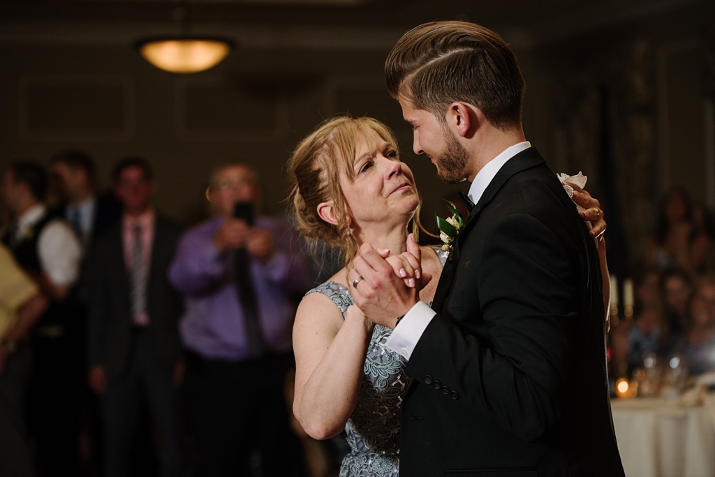 groom dances with mother at wedding reception