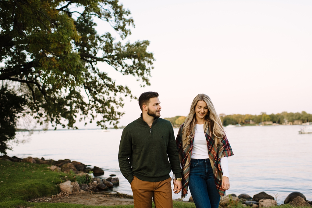 couple walking lakeside in minnesota fall